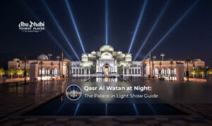 Qasr Al Watan at night illuminated against the Abu Dhabi skyline.